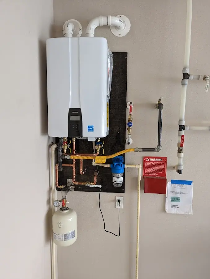 Professional plumber installing copper piping in a Pleasant Run Farm home